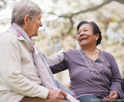 Image of Elderly women sitting on bench in park smiling happy life long friends enjoying retirement