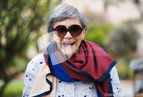 Image of Portrait of happy old woman laughing wearing sunglasses