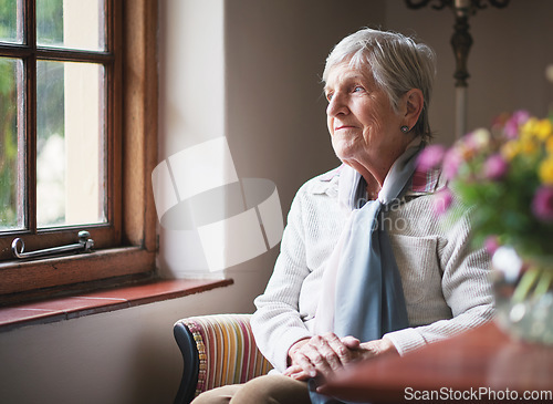 Image of Happy elderly woman looking out window thinking of memories pensioner retirement lifestyle concept