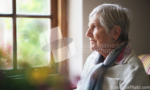 Image of Happy elderly woman looking out window thinking of memories pensioner retirement lifestyle concept