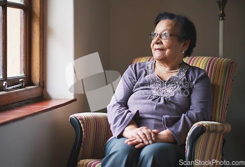 Image of Happy elderly woman looking out window thinking of memories pensioner retirement lifestyle concept