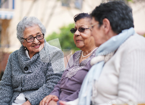 Image of Happy elderly women sitting on bench in park smiling best friends enjoying retirement together