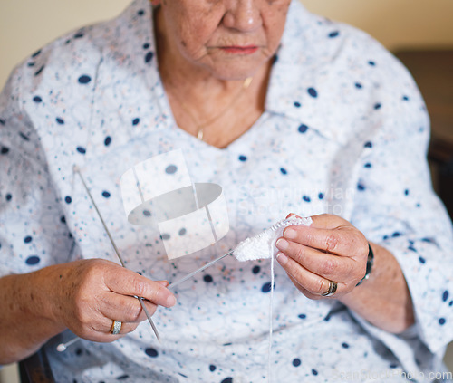 Image of Elderly woman hands knitting at home