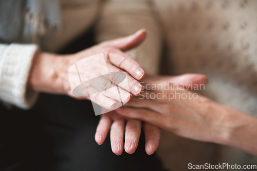 Image of Elderly woman holding hands with daughter