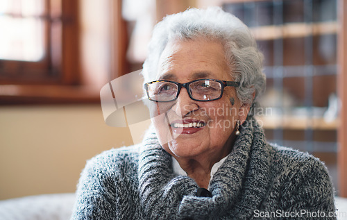 Image of Portrait beautiful elderly woman smiling sitting on sofa at home enjoying retirement