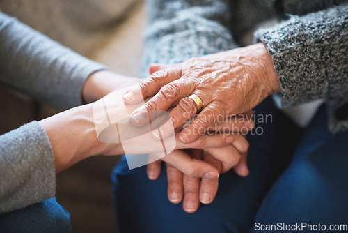 Image of Elderly woman holding hands with daughter