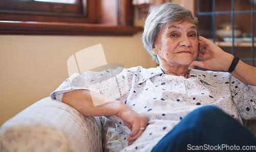 Image of Portrait happy elderly woman smiling sitting on sofa at home enjoying retirement