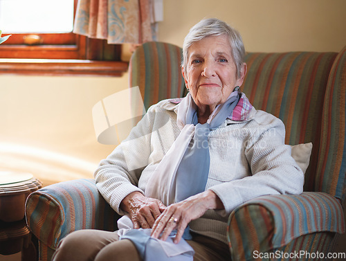 Image of Happy elderly woman smiling sitting on sofa at home enjoying retirement