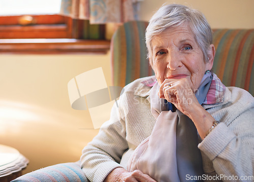 Image of Portrait happy elderly woman smiling sitting on sofa at home enjoying retirement