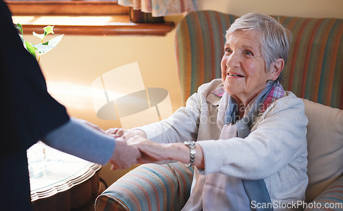 Image of Nurse helping old woman holding hands in retirement home