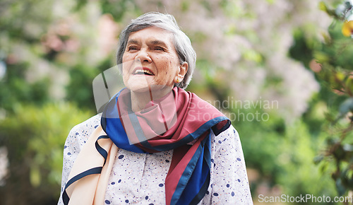 Image of Portrait happy old woman smiling enjoying retirement wearing colorful scarf in beautiful garden