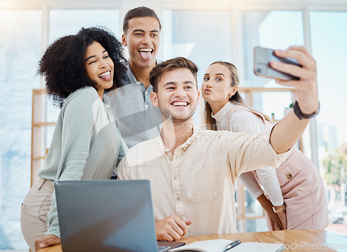 Image of Office selfie with happy corporate colleagues having fun and being goof, silly face expressions while bonding. Young, diverse work friends relaxing on a break, being playful after a productive day