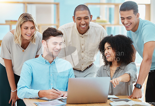 Image of Happy business people watching a laptop in an office, laughing and bonding during a conference call. Diverse team discussing strategy while looking at an online presentation together, sharing ideas