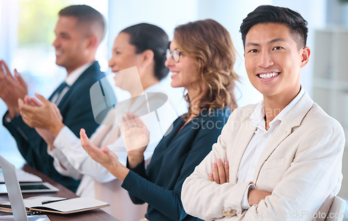 Image of Teamwork, motivation and celebration with clapping business people cheering during speech or presentation. Portrait of a happy employee enjoying his career while sitting with diverse team in training