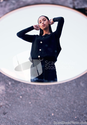 Image of Fashion, beauty and mirror reflection of trendy look, style or clothes of a woman feeling confident in black. Portrait, art deco and beautiful youth influencer or model standing on the street