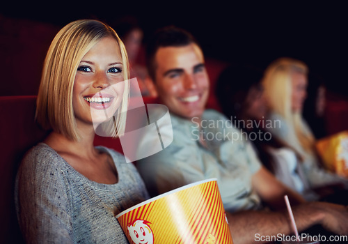 Image of Movie, popcorn and smile with woman on a date with man at cinema interior or theater event. Happy, film or show screen with couple eating snacks and watching together at night time