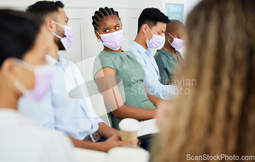 Image of Covid, mask and workshop with business people in a conference or presentation for training, learning and education. Man and woman talking in a meeting or seminar during the corona virus epidemic