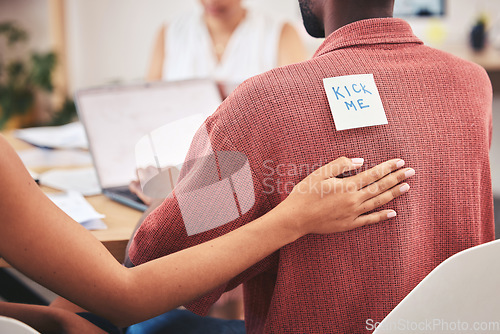 Image of Office prank, comic and work bullying of a corporate team placing a kick me sticky note. Working, collaboration and business teamwork playing a april fool funny, comedy and joke on a employee