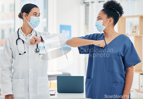 Image of Woman doctor and nurse, in a hospital elbow greeting, in surgical mask during the covid pandemic. Teamwork, healthcare worker and medical professional with protection from virus during consultation