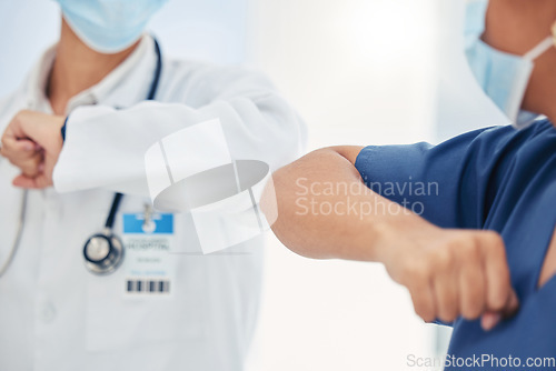 Image of Covid handshake of a nurse and doctor as a surgery success, welcome or support gesture. Medical and healthcare workers working in a hospital, wellness clinic of doctors office greeting at work