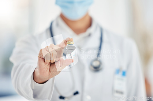 Image of Hand of medical doctor with covid vaccine bottle covid 19 virus pandemic medicine for health vaccination at clinic or hospital. Healthcare worker with corona medication or coronavirus treatment