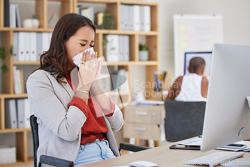 Image of Sick, ill and sneezing business woman with cold, flu or allergy while working at office. Workaholic or manager trying to work at desk with covid disease virus or bad work life balance at workplace