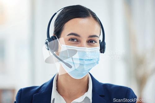 Image of Call center, support or covid help worker with mask for safety and corona protection at work. CRM business telemarketing or customer service consultant consulting on covid 19 contact us question