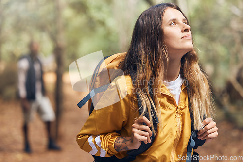 Image of Wellness, nature and adventure with a female backpacker explore a forest, breathing fresh air and looking around. Young woman enjoying the view of the woods while out hiking and having fun