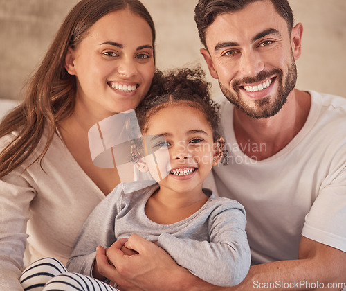 Image of Happy family, girl and an interracial couple smiling and excited about spending quality time together. Portrait of parents, mother and father having fun with their adopted daughter at home