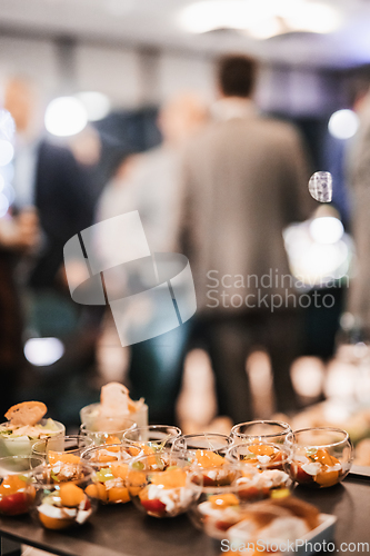 Image of Blurred image of businesspeople at banquet business meeting event. Business and entrepreneurship events concept. Focused on the canapes.