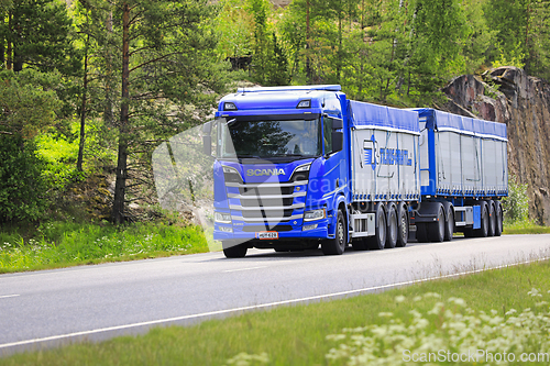 Image of Blue Scania R650 Truck Bulk Commodity Transport Trailer on Road