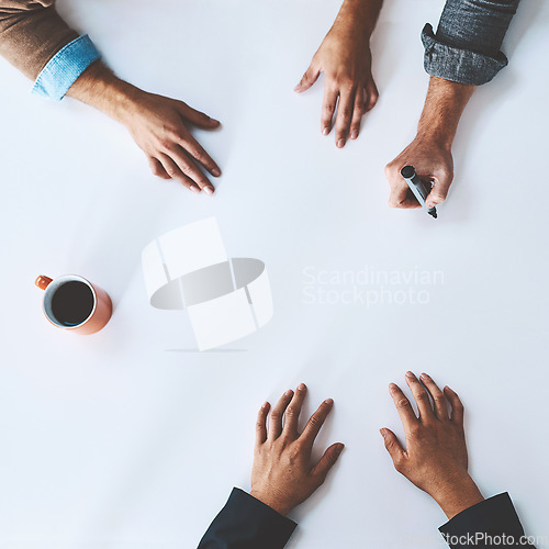 Image of Whiteboard, writing, and closeup of hands isolated at desk or office. Meeting, teamwork and planning session at table together inside. Collaboration, ideas and innovation copyspace from angle above.