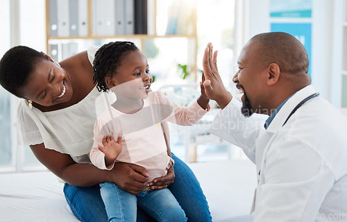 Image of Healthcare, mother and girl gives doctor high five in a doctors office. Medical insurance, healthy child development and consulting in a doctors office. Black woman, daughter and pediatrician smiling