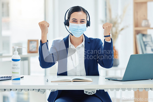 Image of Covid, yes and support with a call center or customer service operator in celebration in an office with a headset. Contact us, crm or telemarketing with a young female in the corona virus pandemic