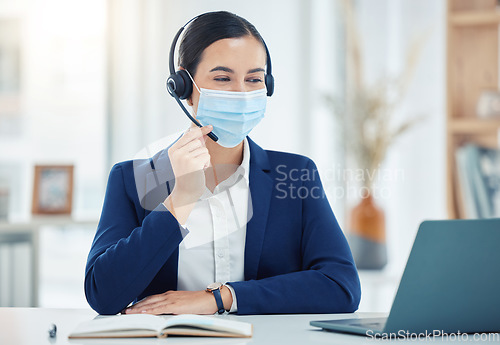 Image of Call center agent with covid giving online service with laptop, working in telemarketing and helping people with communication on pc work office. Latino customer support worker consulting with mask