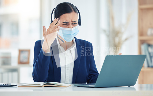 Image of Headache, pain and tired call center agent working on a laptop with headset while wearing face mask. Stressed, burnout and frustrated customer service woman working on computer in a corporate office