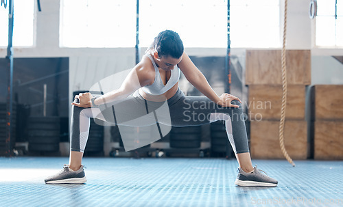 Image of Gym, woman and stretching legs exercise before workout session training for injury prevention. Girl doing joint and muscles warm up for athlete performance and recovery from active fitness.