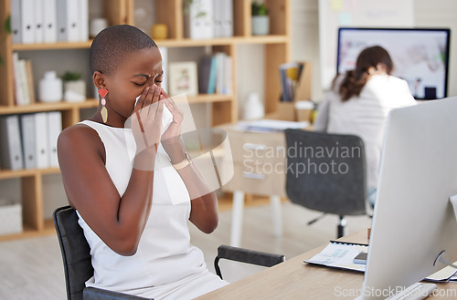 Image of Sick corporate employee suffering with the flu, cold or covid while working in an office. Young professional with sinus or allergy, sneezing and feeling ill at work, blowing nose and uncomfortable