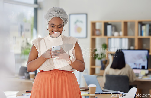 Image of Business woman typing on social media on phone at work, reading email and networking with people online on a smartphone in an office. Happy black woman in communication on internet with technology