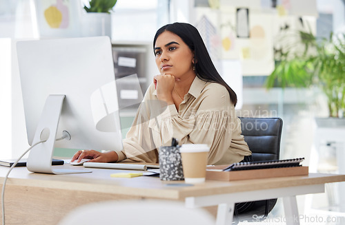 Image of Thinking, attention and business woman on computer working by desk in design company office building. Idea, vision and innovation with employee reading email or looking at work online
