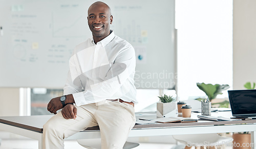 Image of Black business man, leader and office in happy, proud and confident success for company goals in the corporate workplace. African guy in success at desk with smile in management and leadership work