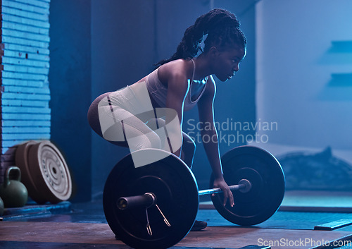 Image of Strong, black woman and focus barbell fitness to deadlift workout, heavy exercise and dark gym training. Powerful athlete, bodybuilder muscles and motivation challenge for sports squat weightlifting