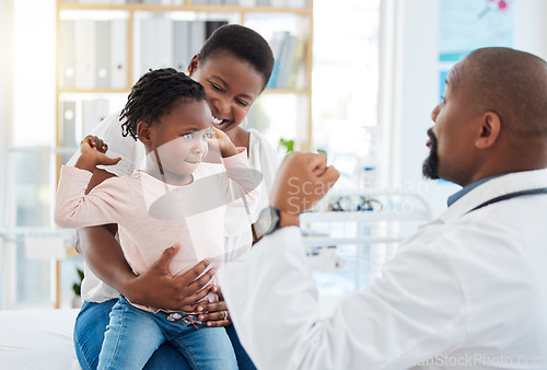 Image of Pediatrician doctor with black family, baby and mother in clinic or hospital checkup appointment for growth wellness. Child in strong muscle flex for calcium with fun male medical pediatrics expert