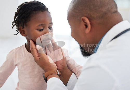 Image of Medical doctor checking a girl throat with care in his office at a modern surgery center. Man pediatrician touching the patients neck during healthcare, medicare and illness consultation at clinic
