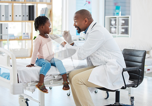 Image of Doctor, mouth of child and black man helping little girl in checkup or consultation at a hospital. Medical male expert or pediatrician examining kid for throat infection, illness or sore in clinic.