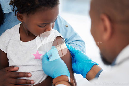 Image of Child, healthcare vaccine and doctor with plaster for skin protection after injection appointment. Black kid and medical worker with bandage for healing of wound from needle medicine immunity.