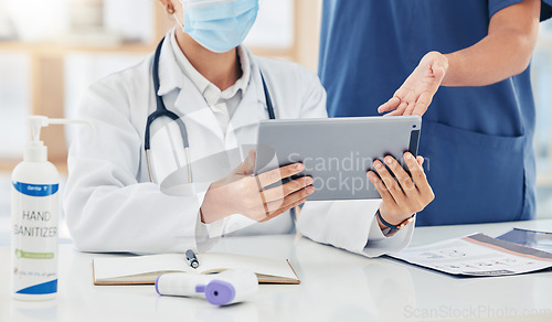 Image of Doctor, hands and tablet with a healthcare team doing research online in a hospital for medical, medicine or wellness. Teamwork, collaboration and working together for treatment, cure and recovery