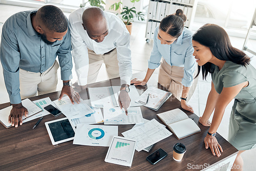 Image of Business people, analytics and collaboration meeting in planning at the office with graphs, charts or documents. Diverse team or group in analysis checking paperwork of company statistics in teamwork