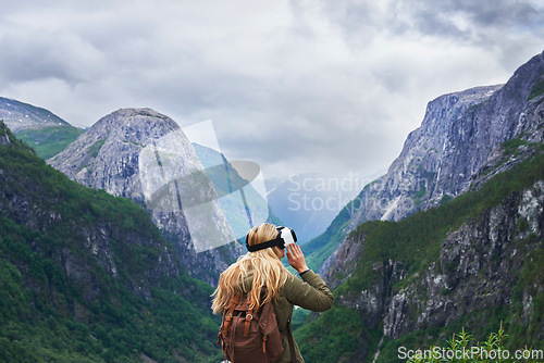 Image of Adventure woman wearing vr headset augmented virtual reality in beautiful mountain landscape concept
