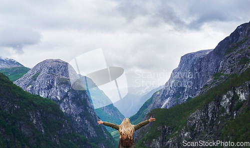 Image of Travel adventure woman celebrates arms raised at view of majestic glacial valley on exploration discover beautiful earth